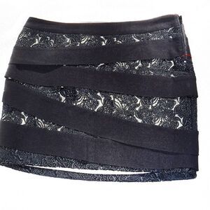 Bebe black lacy bandage mini skirt